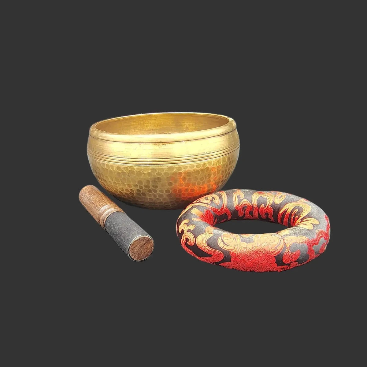 Tibetan singing bowl, the striker (also known as a mallet). and the red and black bowl cushion, is included with purchase.