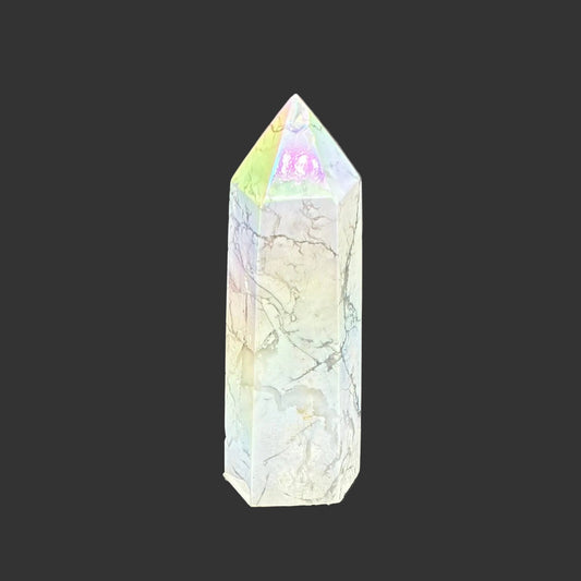 This is the front side of this polished Howlite aura point. It is mostly white some spring overtones