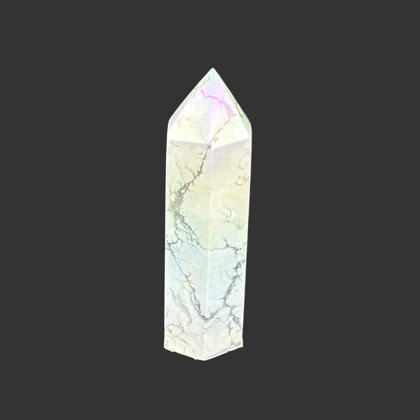 This is the left side of this polished Howlite aura point. It has a overtone of blue, yellow, and pink.