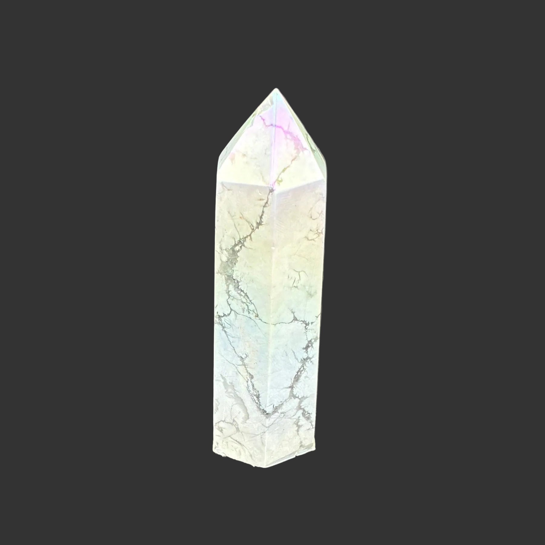 This is the left side of this polished Howlite aura point. It has a overtone of blue, yellow, and pink.