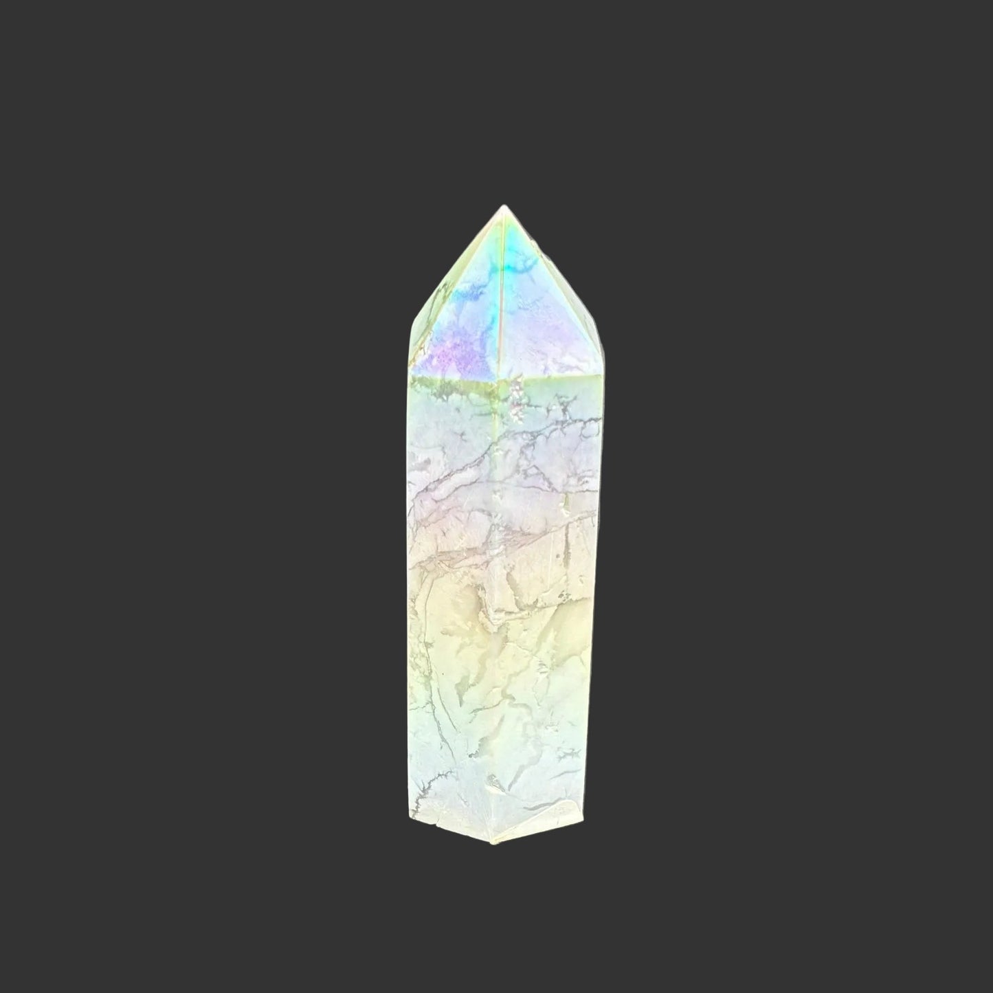 This is the right side of this polished Howlite aura point. It is white with a overtone of blue, yellow, and pink.