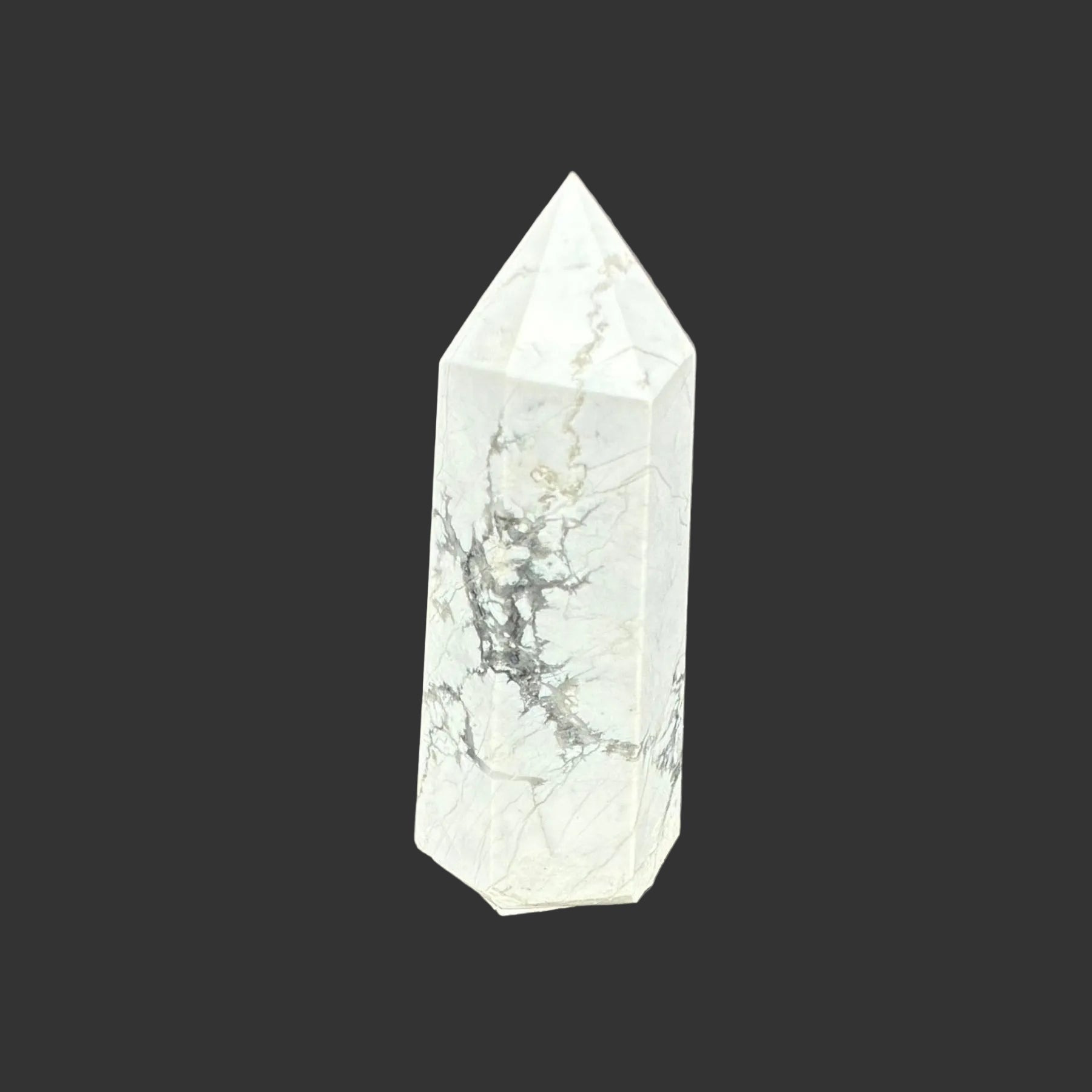 This is the front side of this polished white Howlite tower.