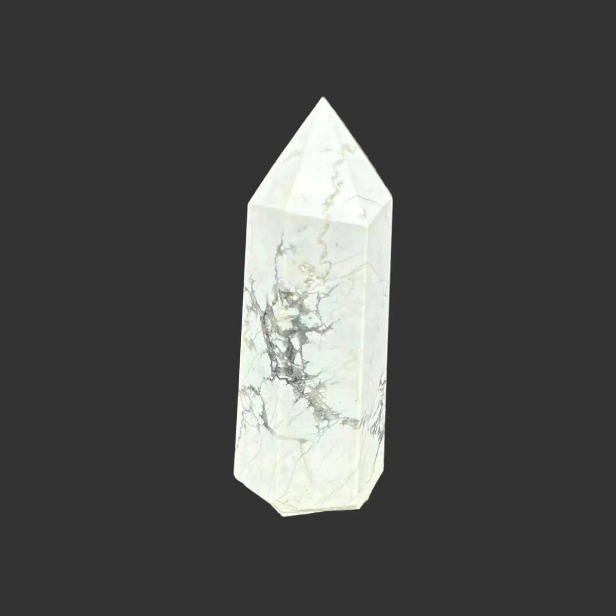This is the front side of this polished white Howlite tower.