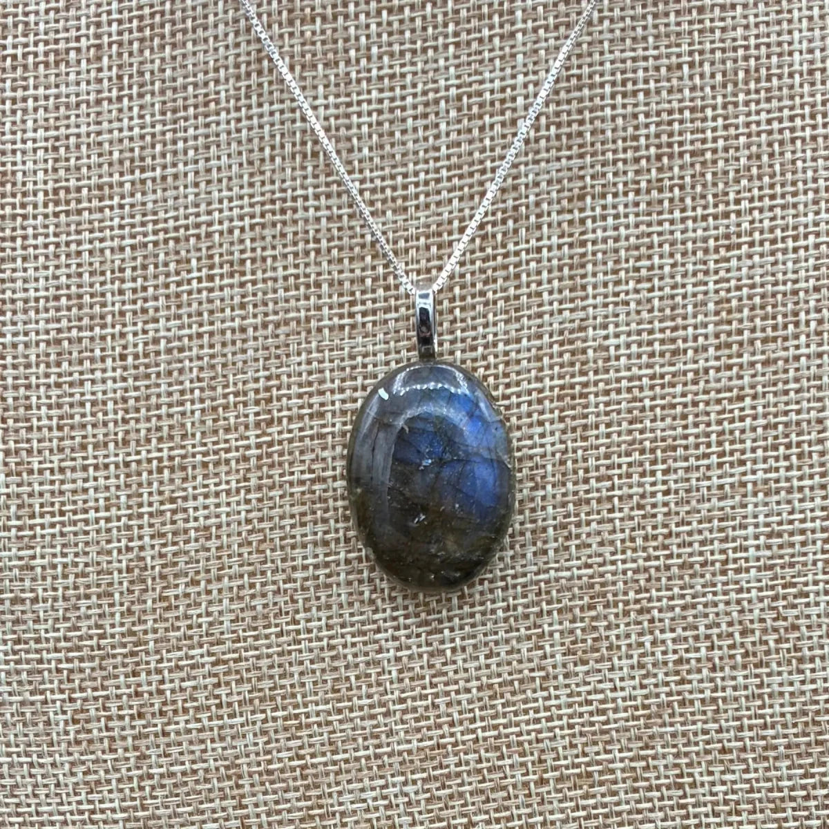 This is a close up of a polished Labradorite pendant.