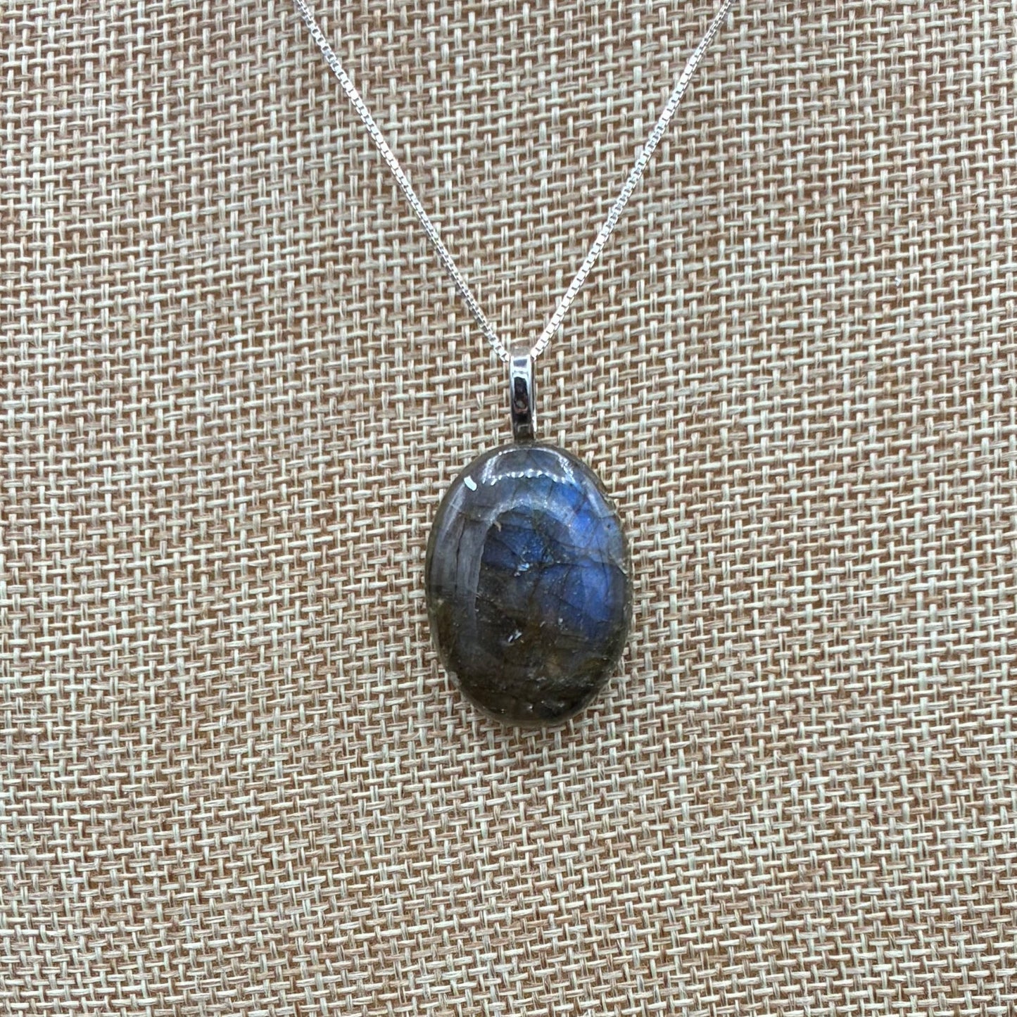This is a close up of a polished Labradorite pendant.