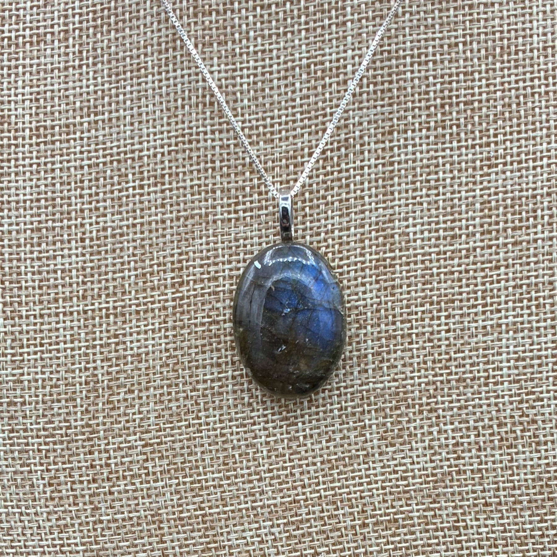 This is a close up of a polished Labradorite pendant.