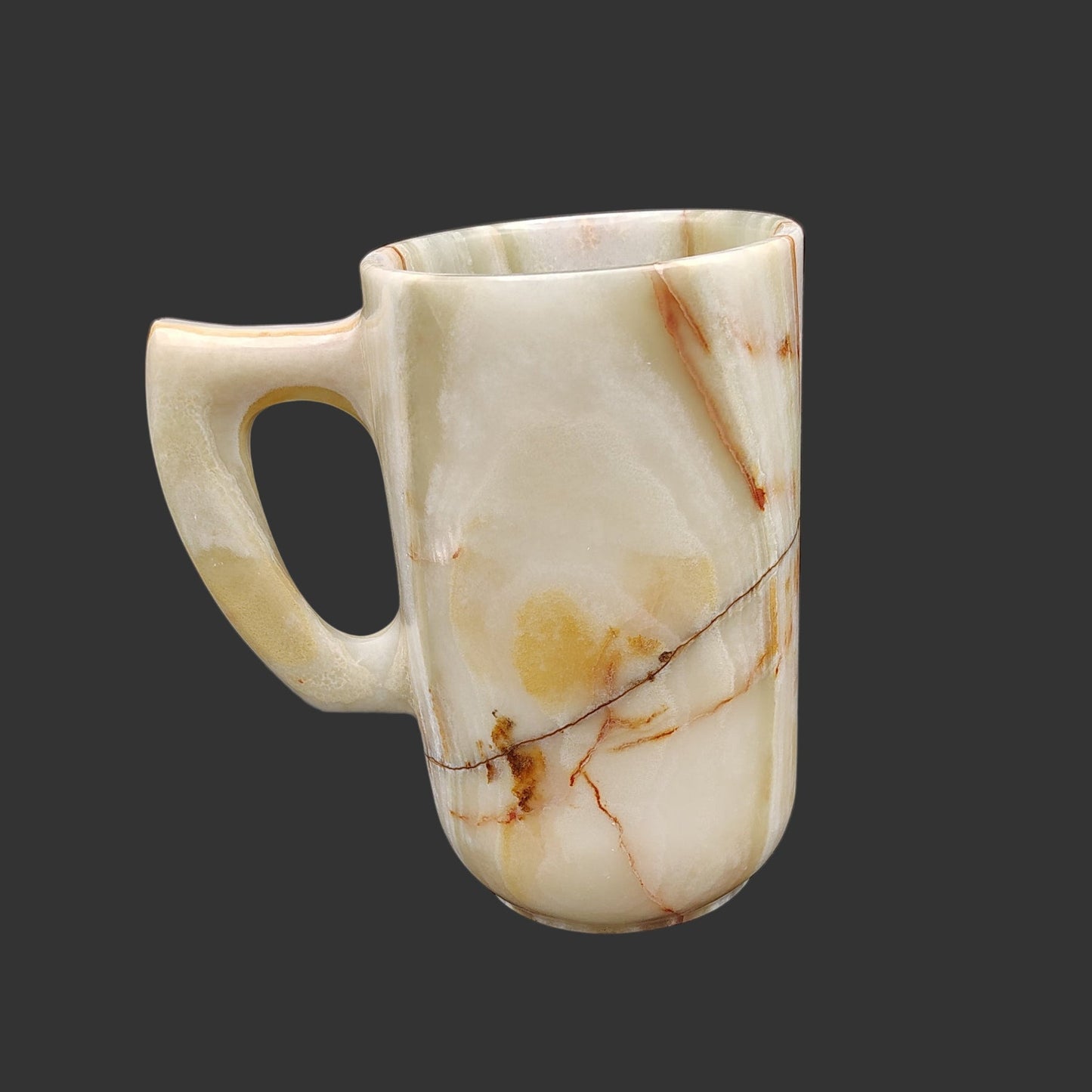 The right side of this onyx mug is mostly cream, a line of black, and brown and orange.