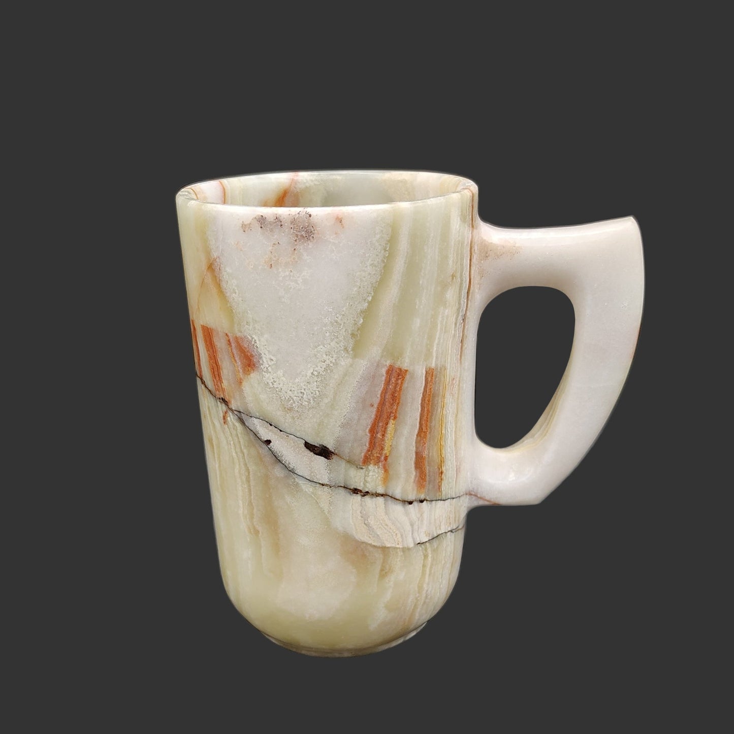 The inner and outer surface of mug is polished. The left side of this Onyx mug is mostly cream with patterns of green, brown