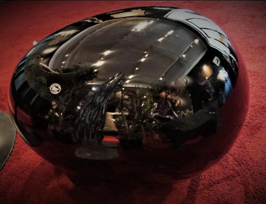 Large Black Obsidian Egg On Burgundy Carpet