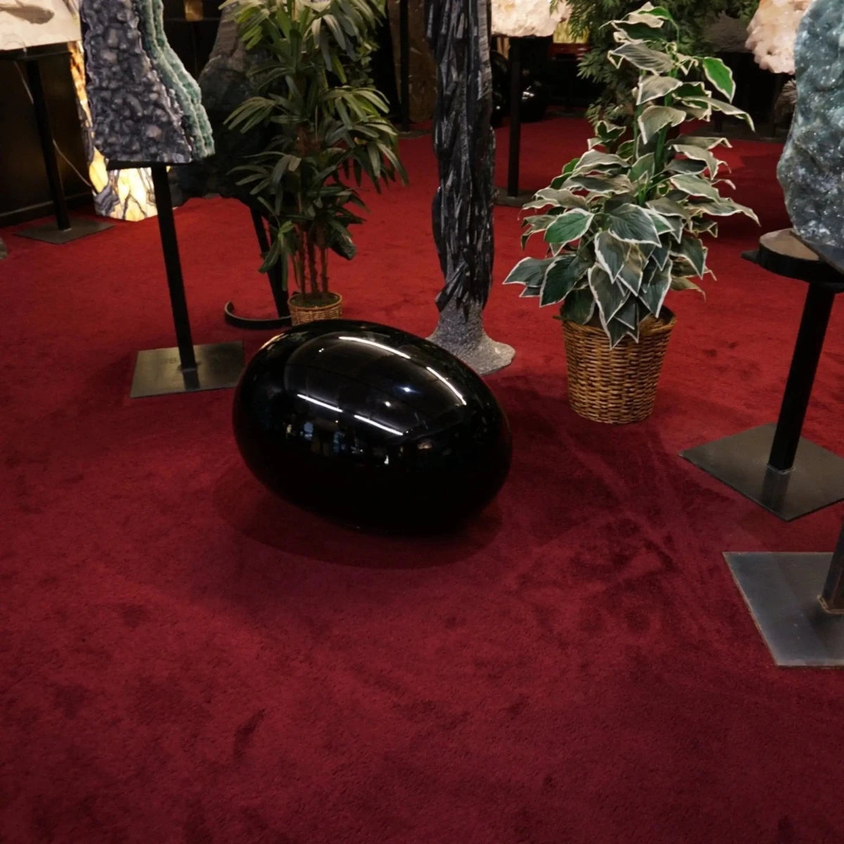 Large Black Obsidian Egg With Other Minerals In The Background