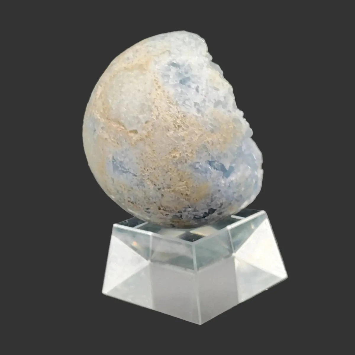 This is the side view of this blue Celestite sphere on a clear acrylic stand.