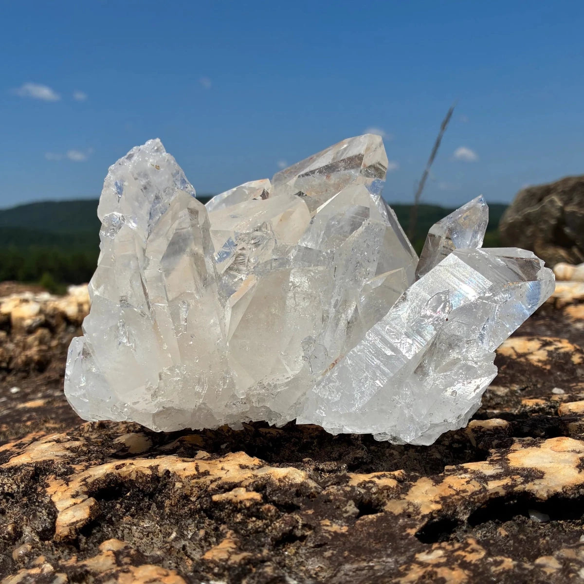 Front side of this quartz crystal cluster, in a outdoor setting.