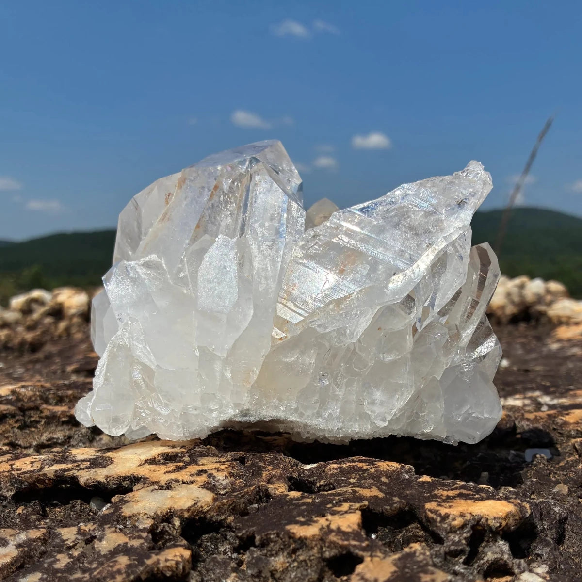 Back side of this quartz crystal cluster, in a outdoor setting.