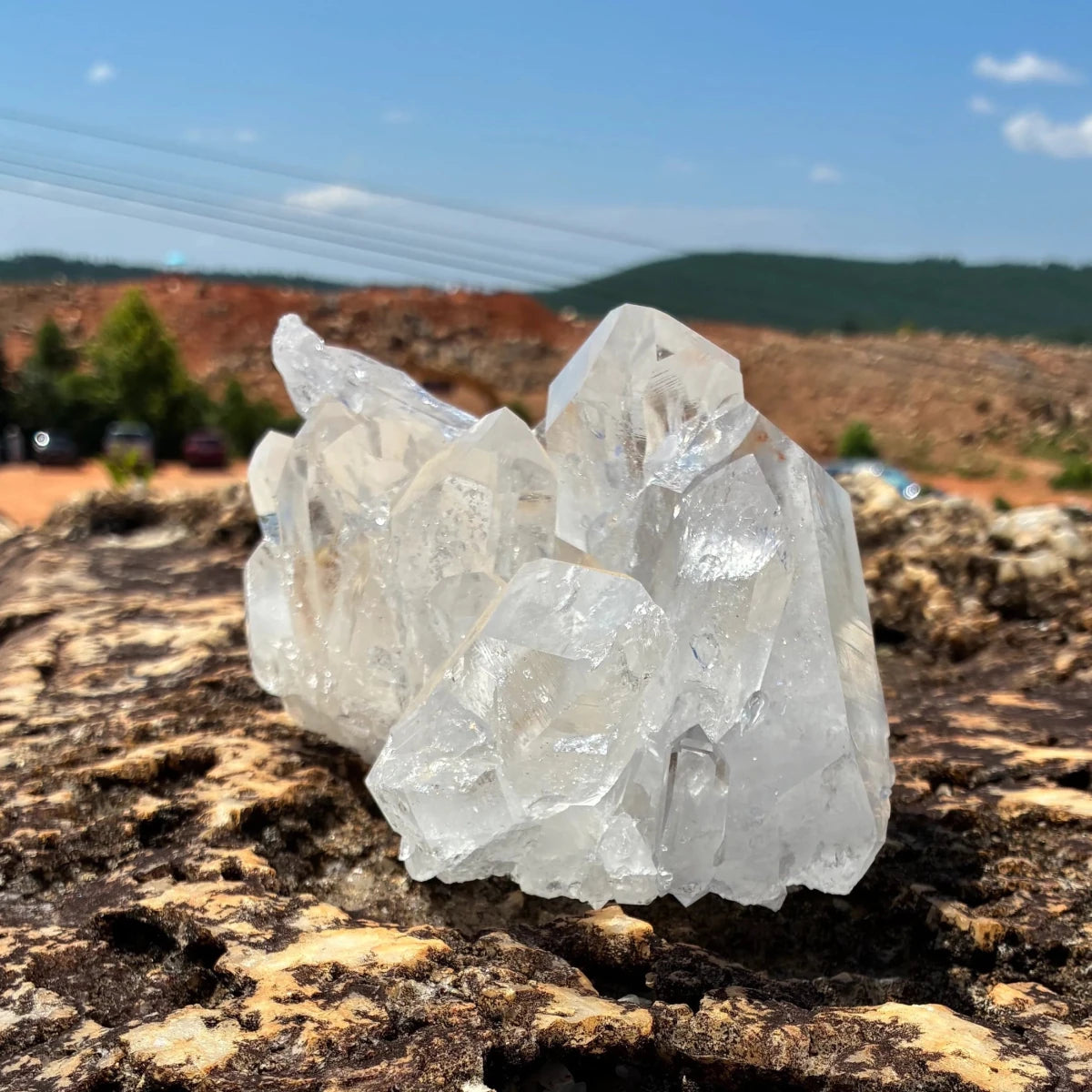 Left side of this quartz crystal cluster, in a outdoor setting.