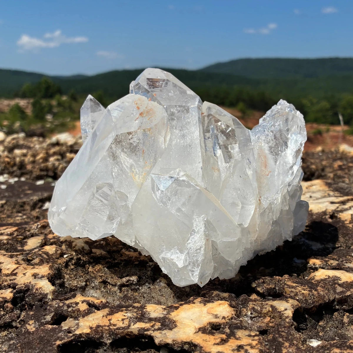 Right side of this quartz crystal cluster, in a outdoor setting.