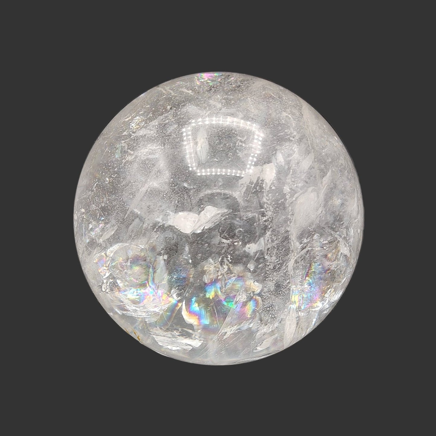 this is the front view of this large and polished quartz crystal ball. You can see a beautiful rainbow of color at the bottom.
