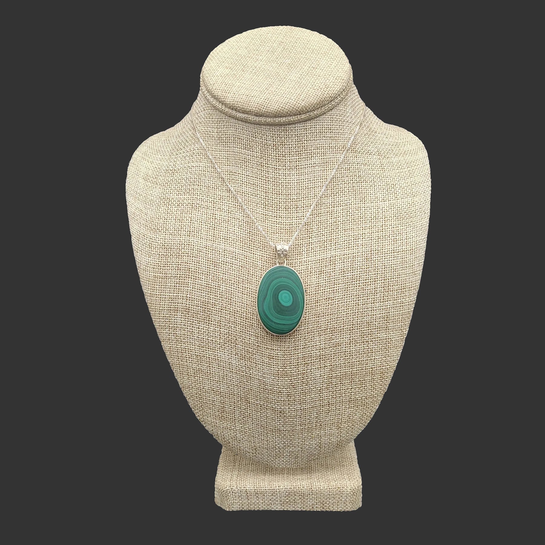 Sterling silver and Green Malachite pendant necklace on a beige mannequin bust against a black background.