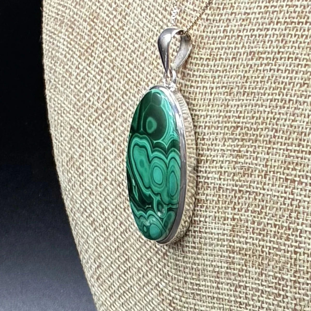 Side view of this sterling silver and malachite pendant.