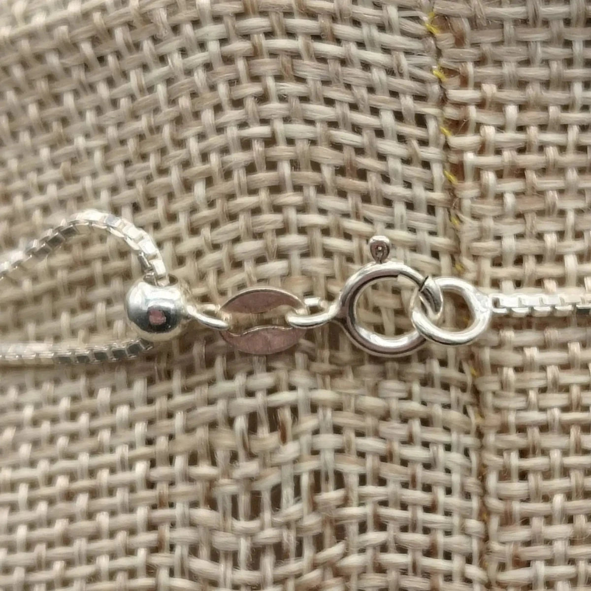 This is a close up of the sterling silver spring ring clasp on this green Malachite necklace.