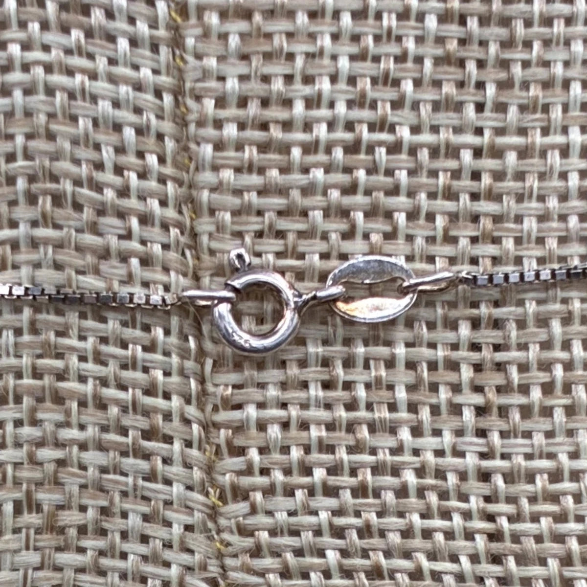 Close up of the sterling silver spring ring clasp on this necklace.