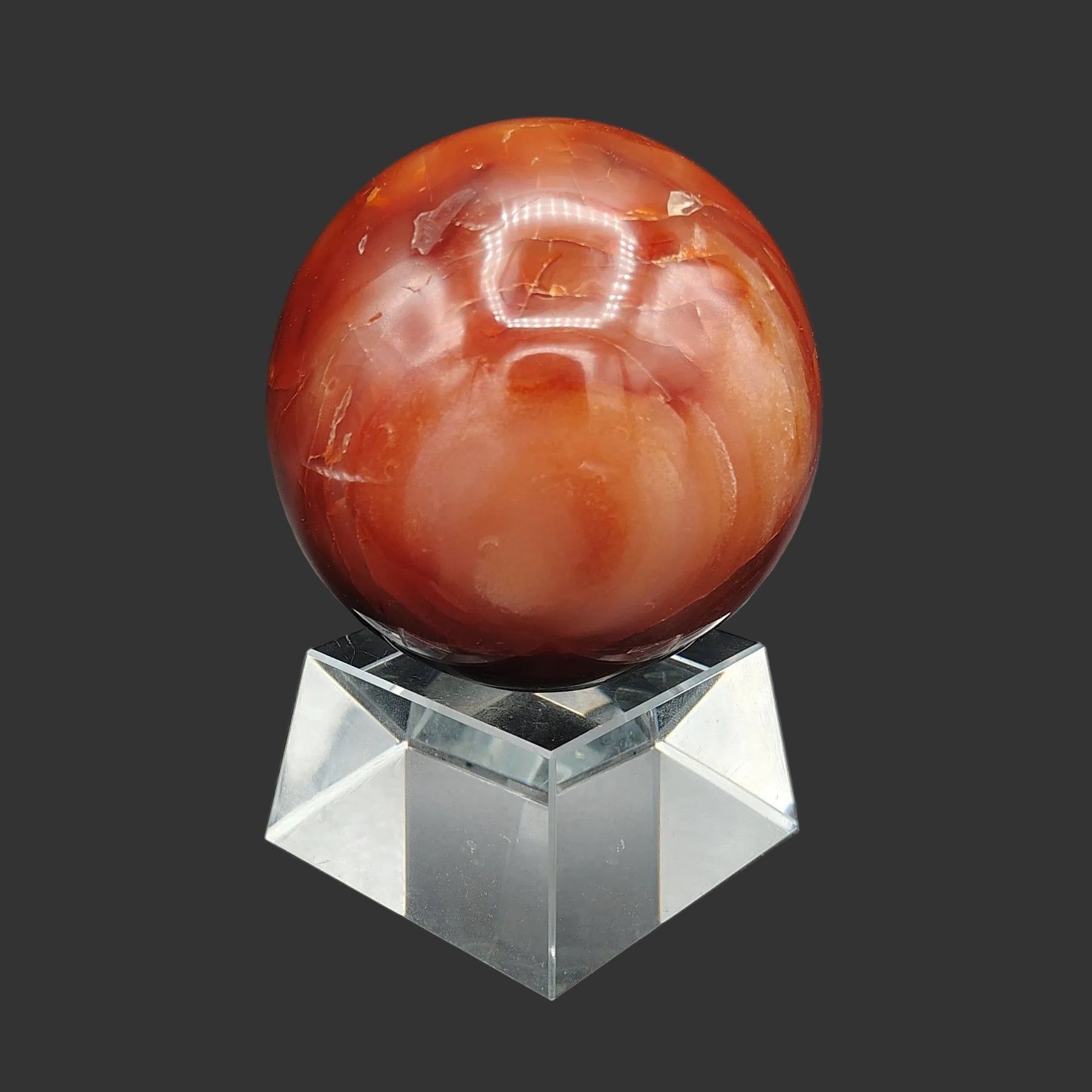This is the right side of this polished red Carnelian sphere.