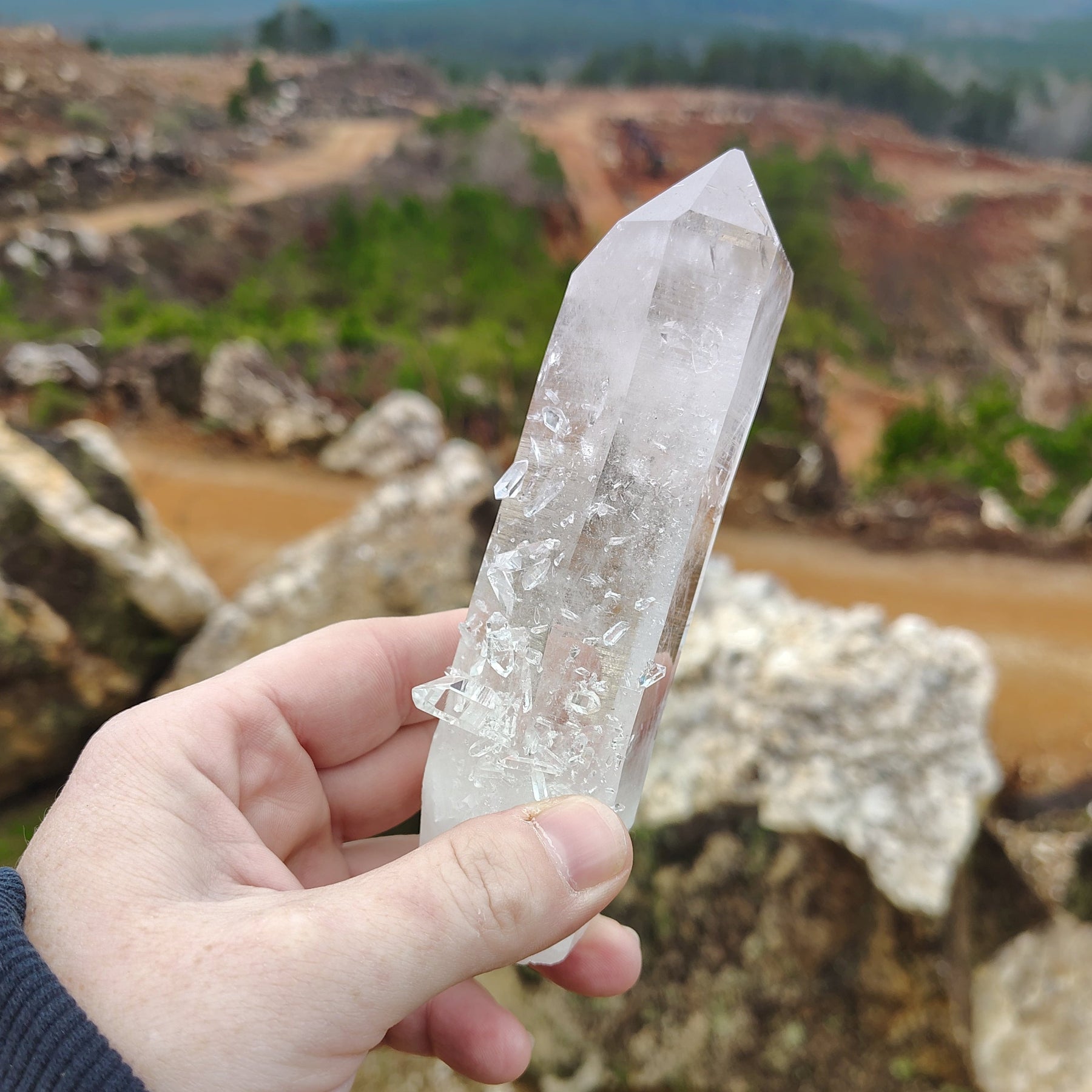 The front side of this large crystal point is covered in allot of smaller quartz crystals.