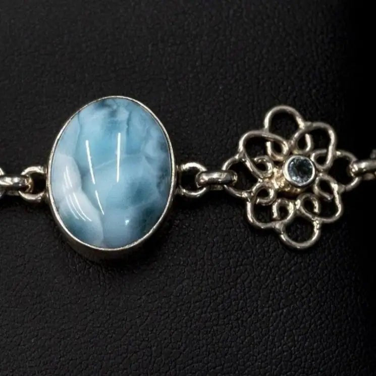 Close Up Of Blue Larimar Cabochon and faceted blue topaz set in sterling bezel