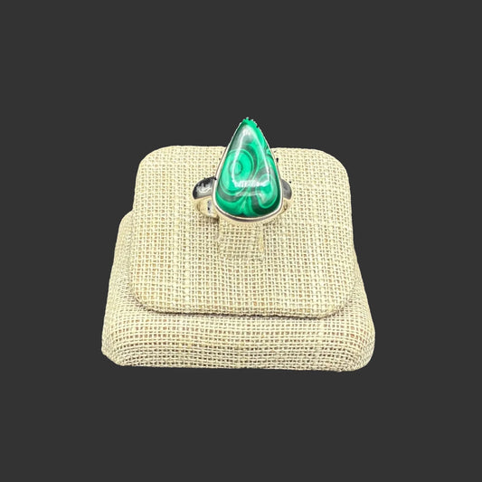 Front view of this Sterling Silver and green malachite ring, in front of a black background.