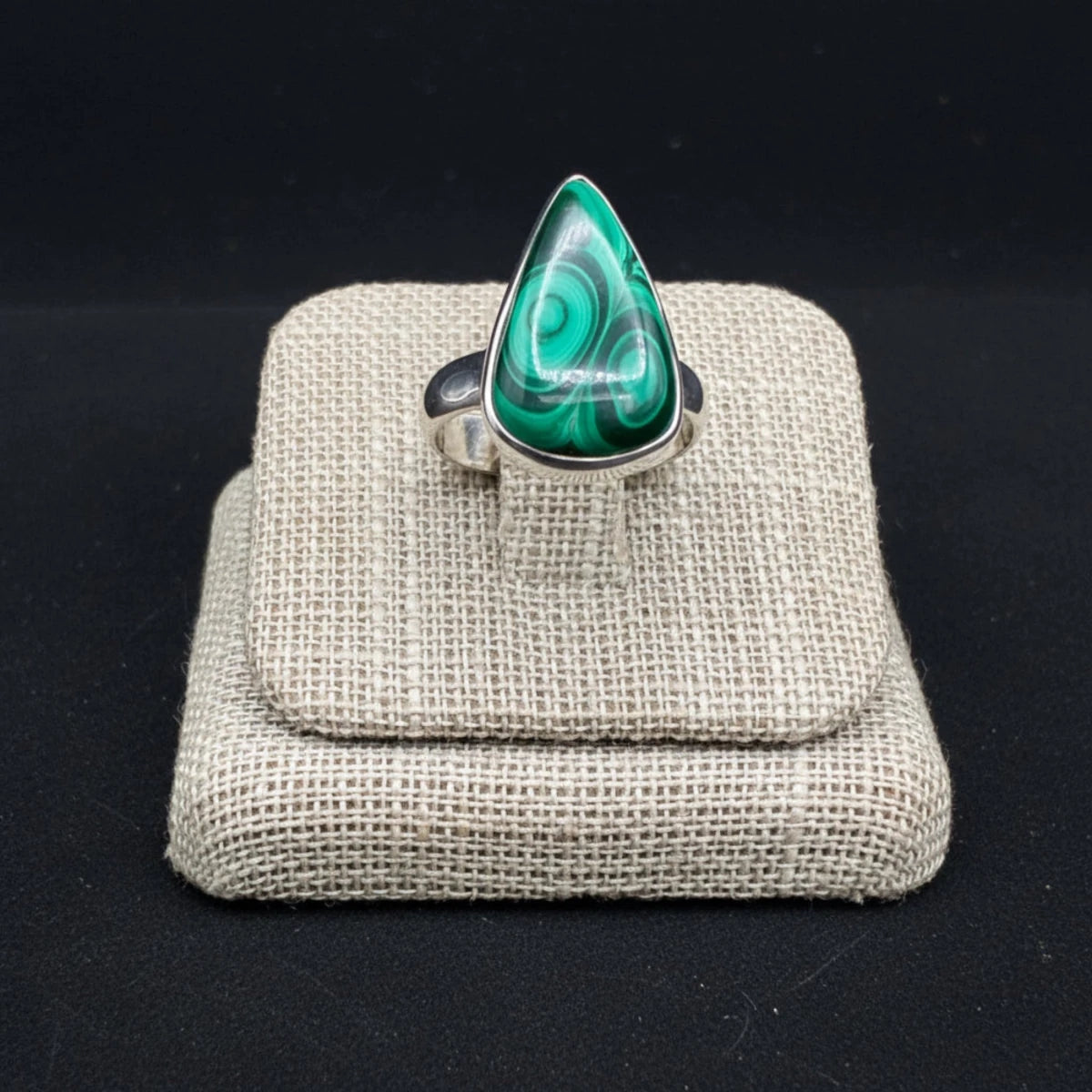 Close up of this Sterling Silver and green Malachite ring, in front of a black background.