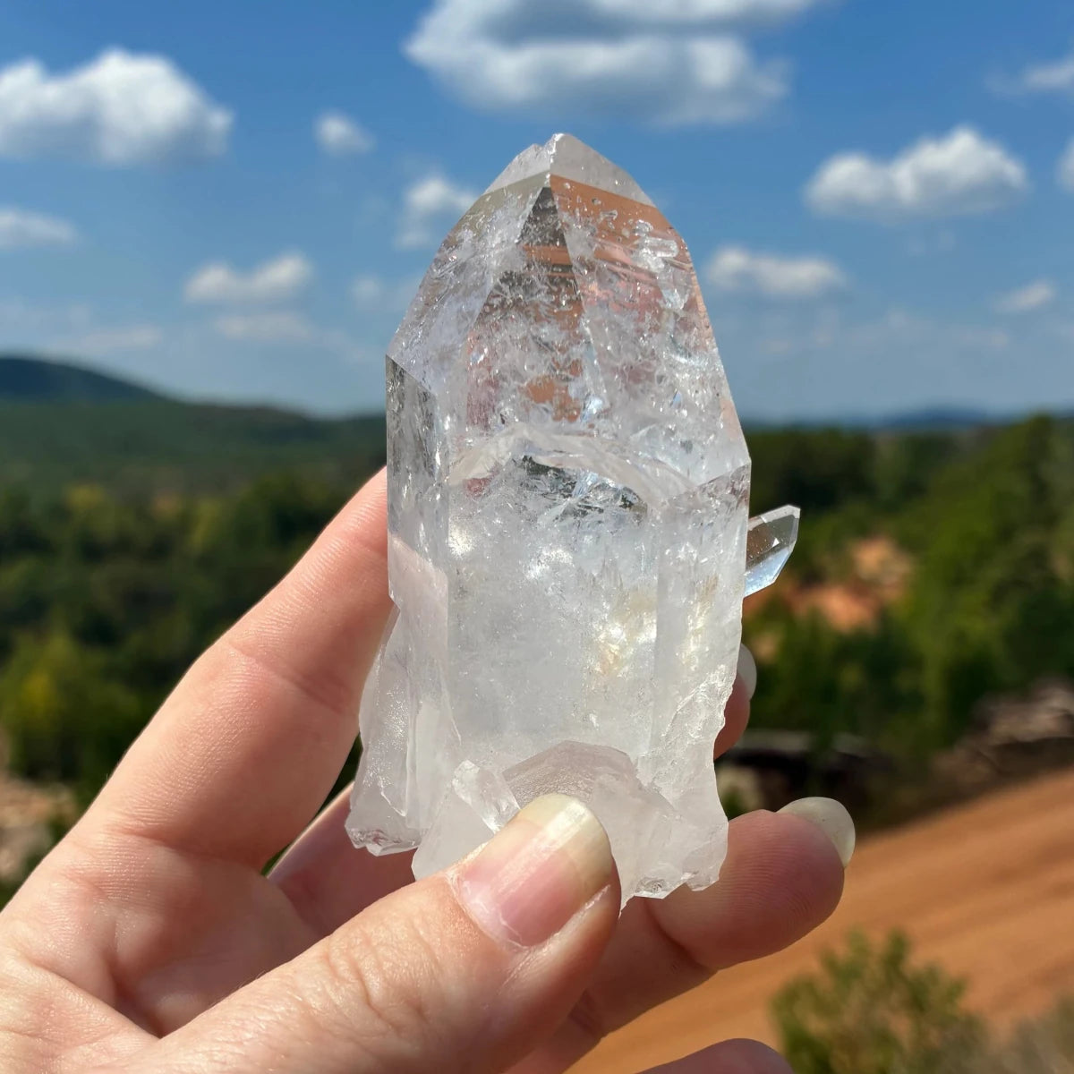 Back side of this quartz crystal point, in front a blue sky.