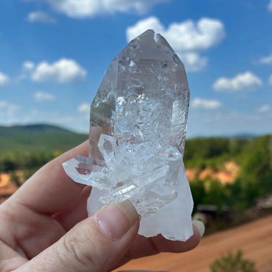 Front side of this quartz crystal point with a blue sky in the background.