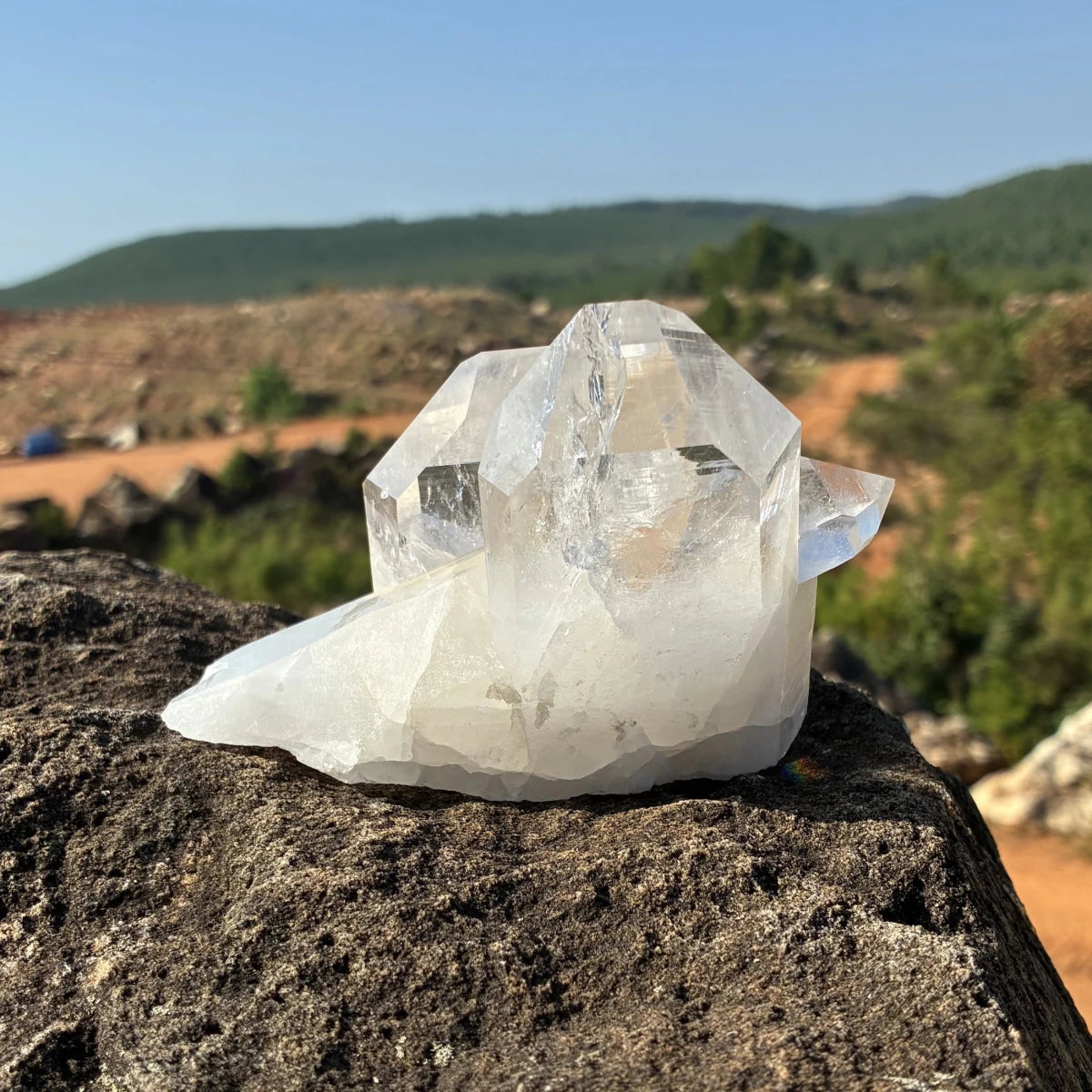 This is the backside of this quartz crystal cluster, on a rock outdoors.