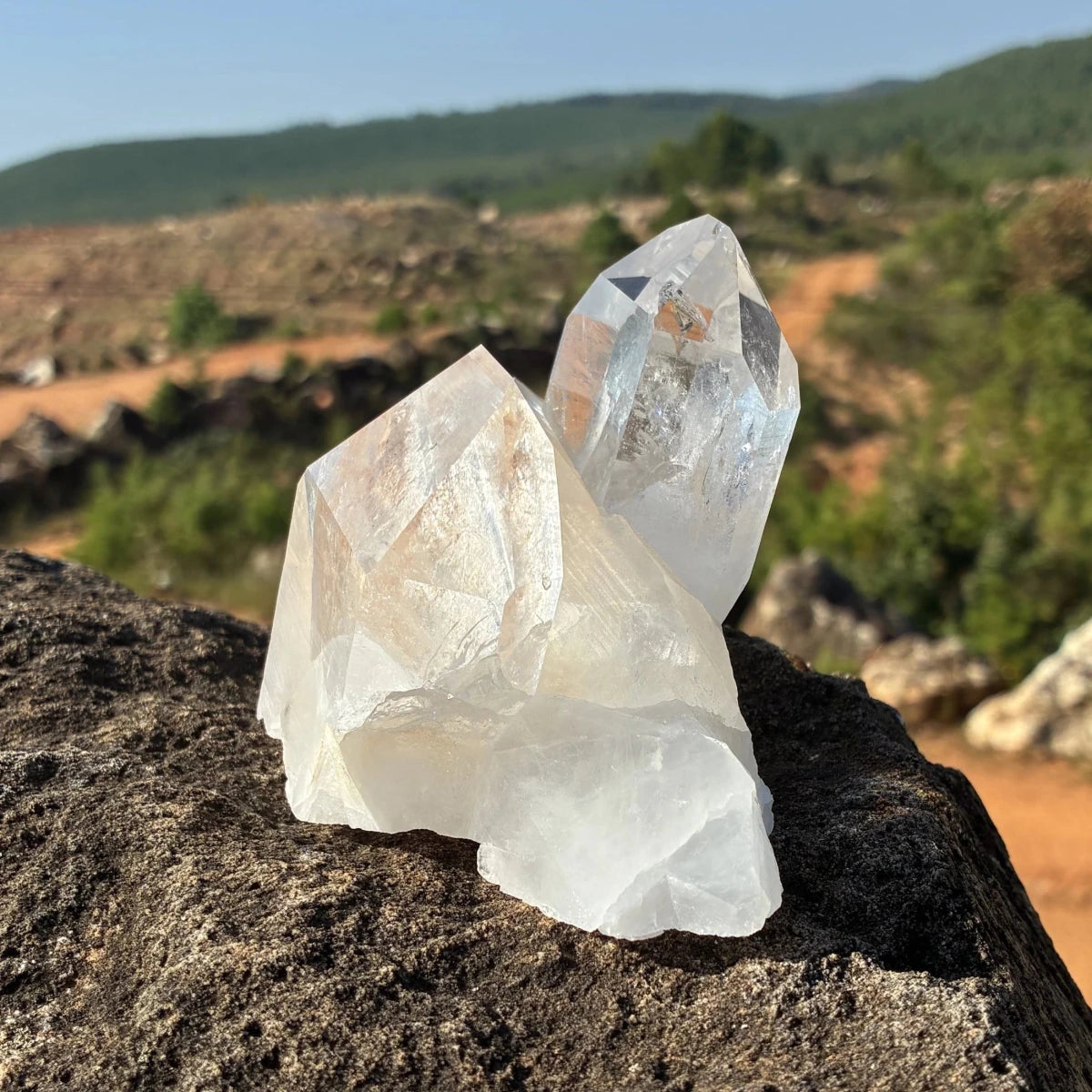 Left side of this quartz crystal cluster, on a rock outdoors. 