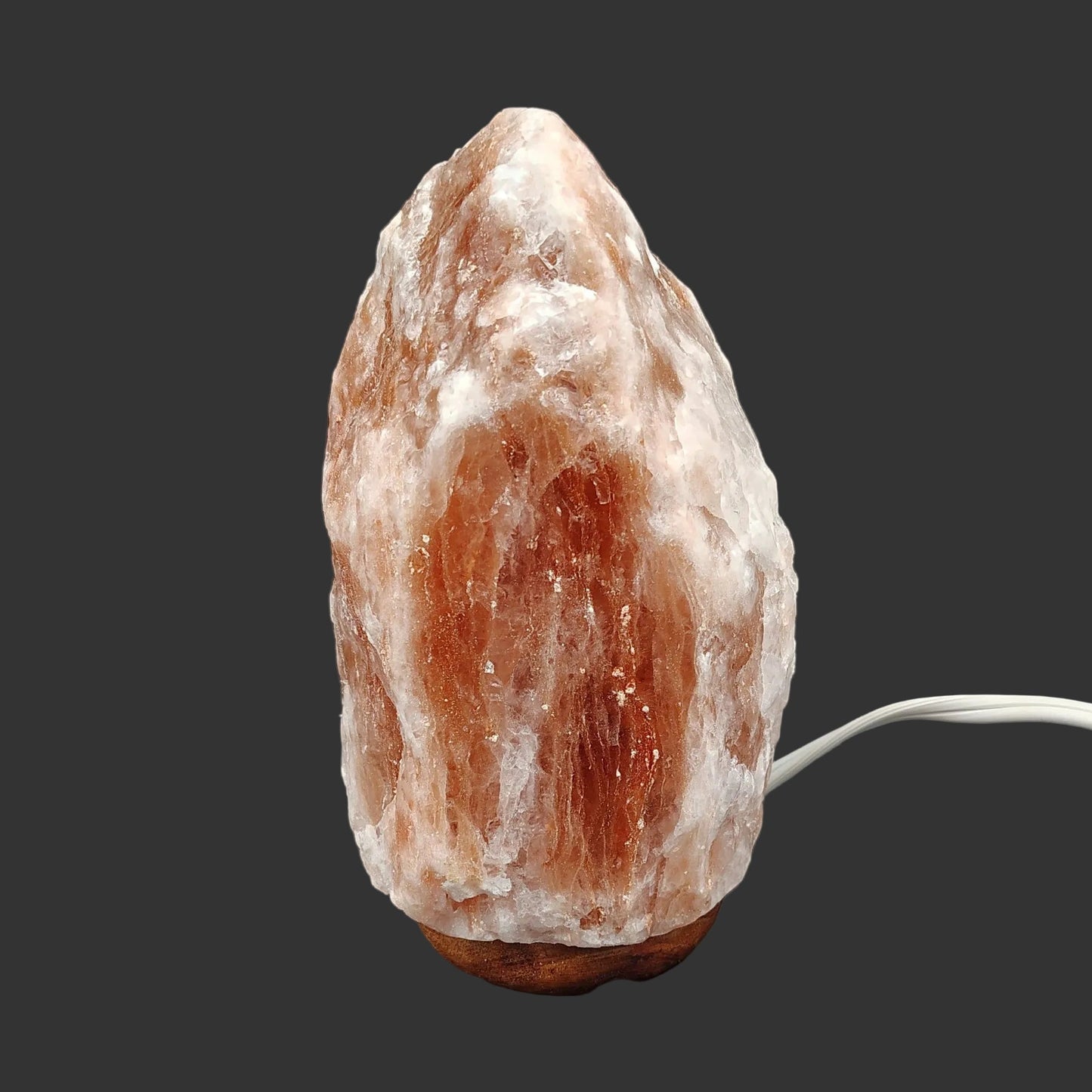 The front view of this pink Himalayan salt lamp with the light turned off.