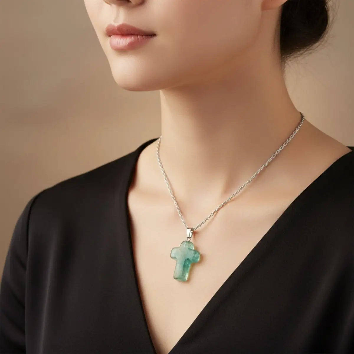 A lady wearing a polished green fluorite necklace on a sterling silver chain.