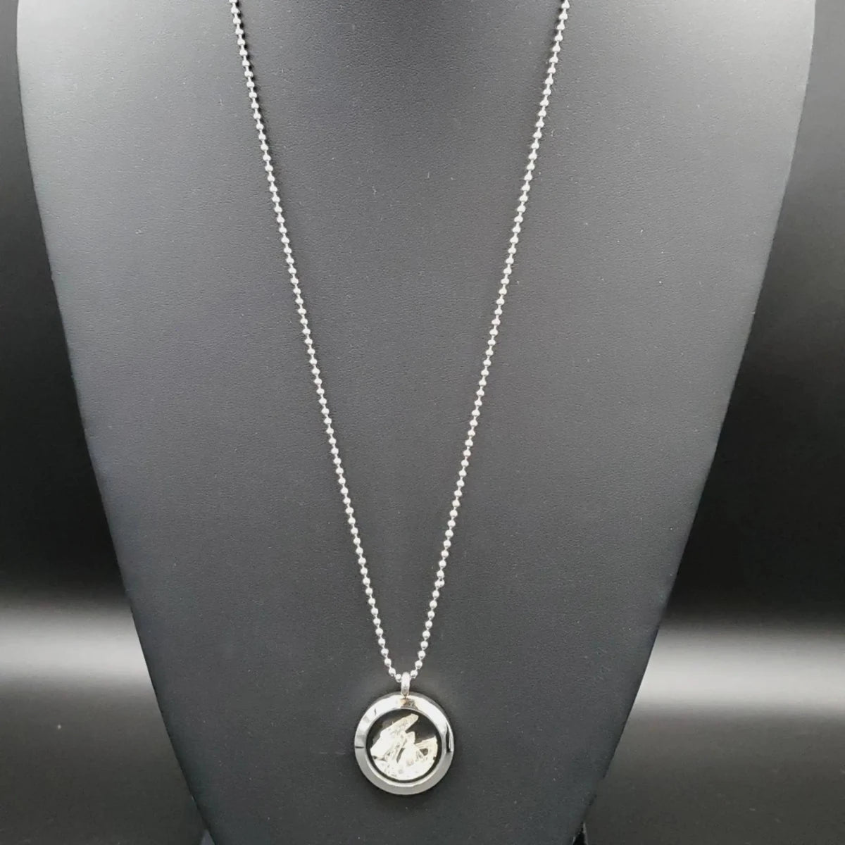 Necklace Clear Locket with Quartz Crystal on a display neck