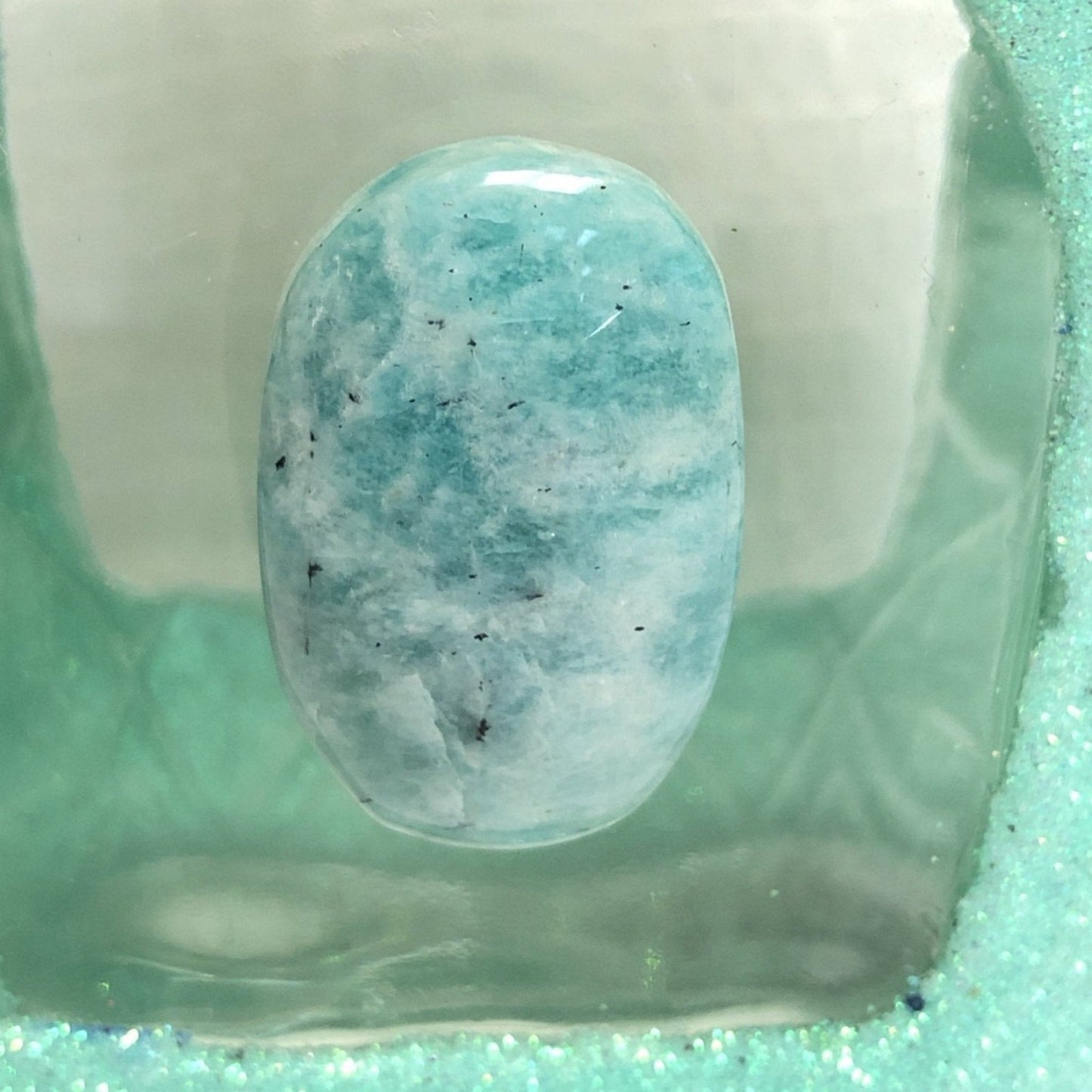 Close Up Of Amazonite Stone On Upcycled Sparkling Mint Green Bottle