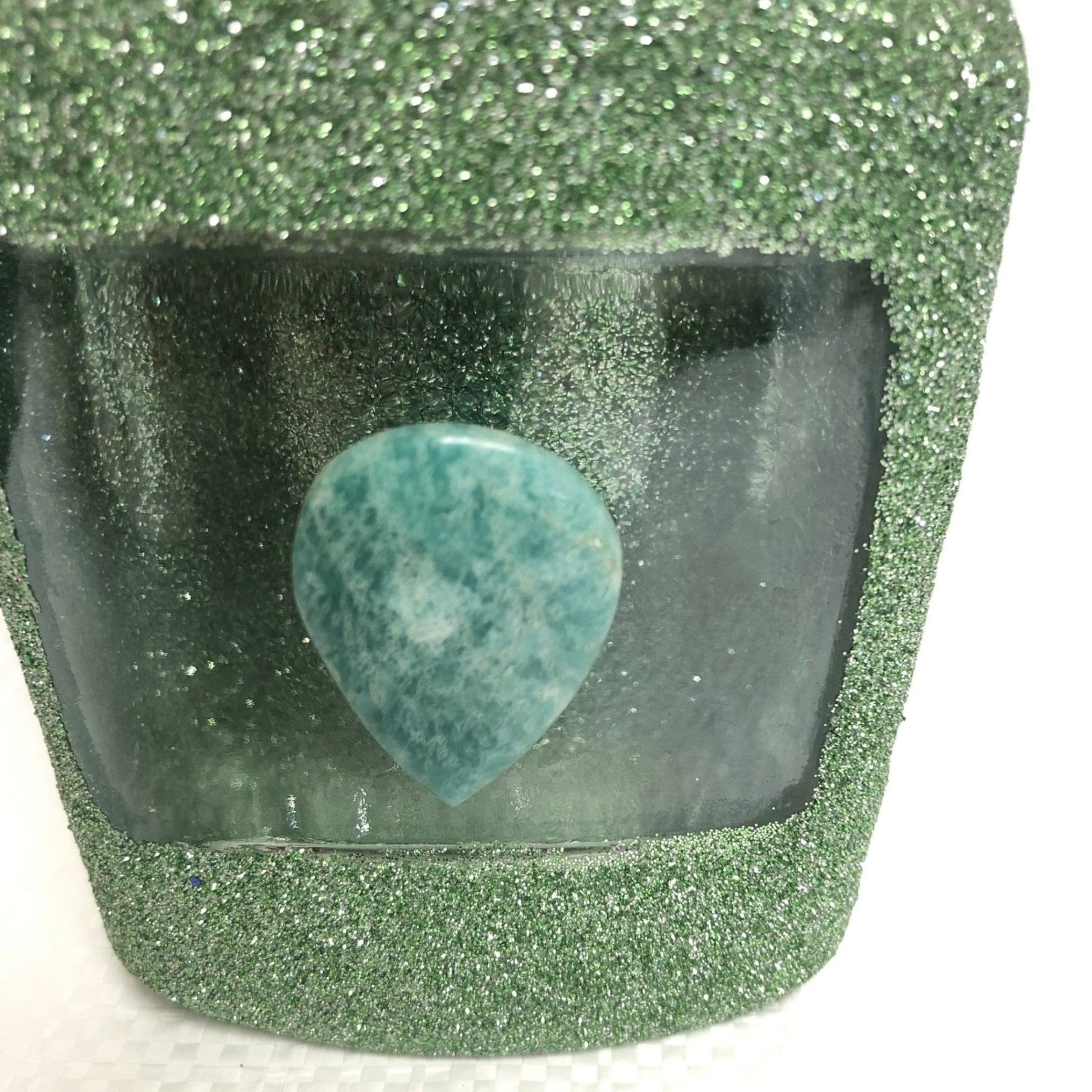 Close Up Of Amazonite Stone On Upcycled Sparkling Green Bottle