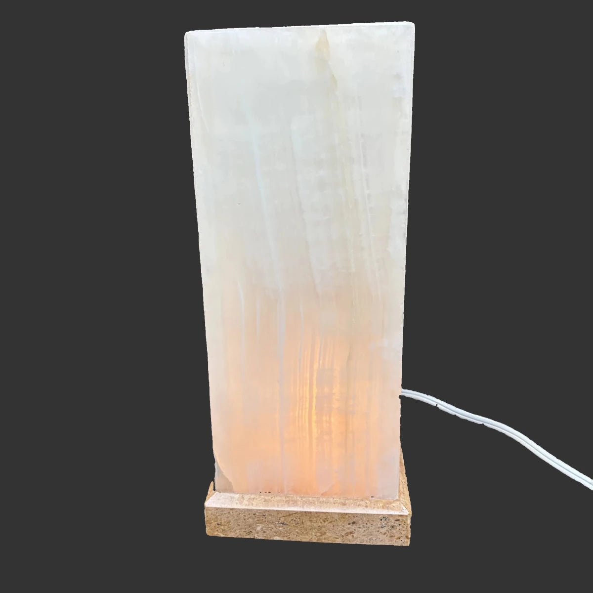 Onyx lamp turned on, in a dark setting