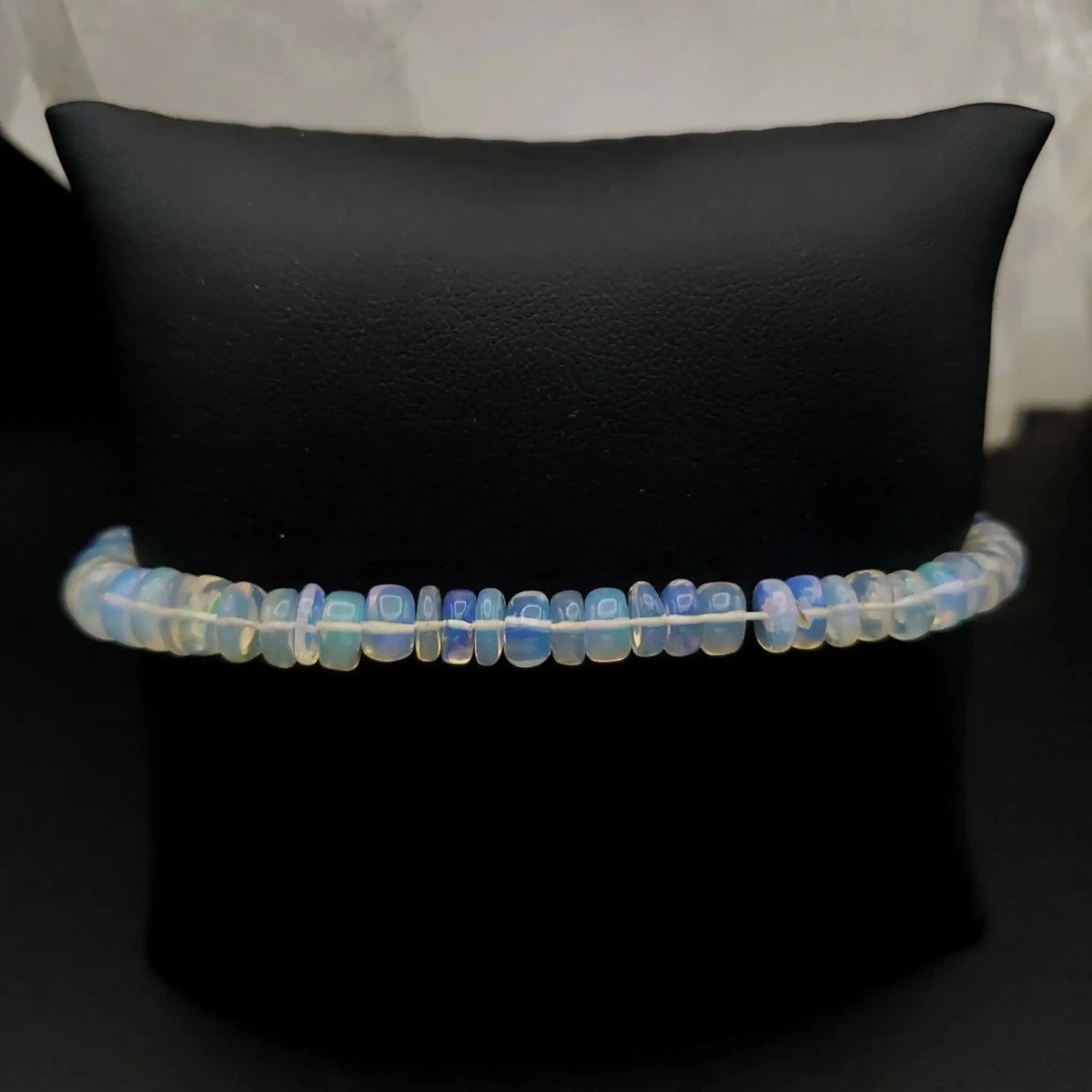 Opal Beaded Bracelet on dark brown pillow display