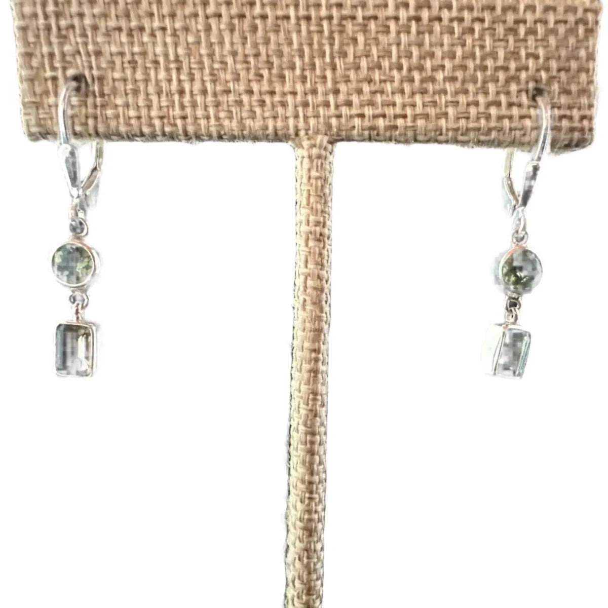 Close Up View Round Brilliant And Emerald Cut Peridot Earrings