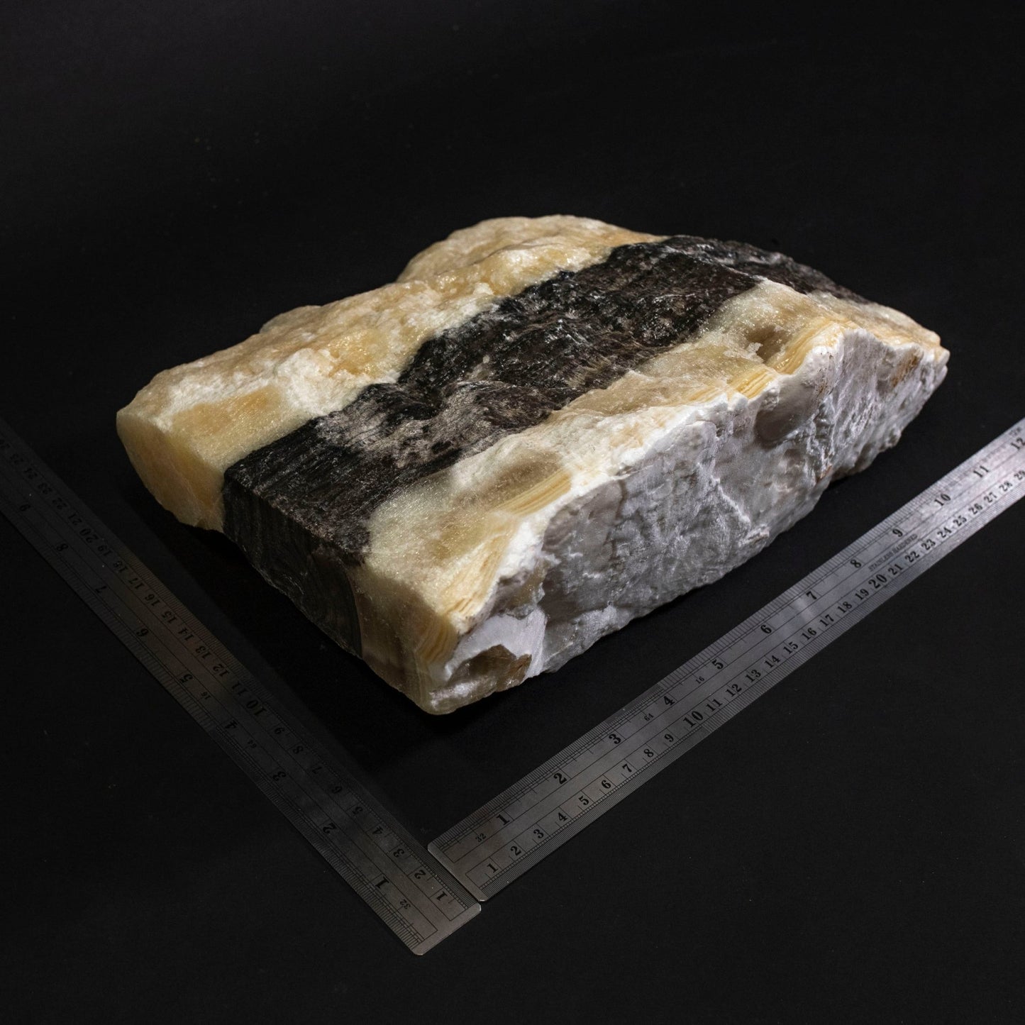 White Stone With Black Stripes and two metal rulers