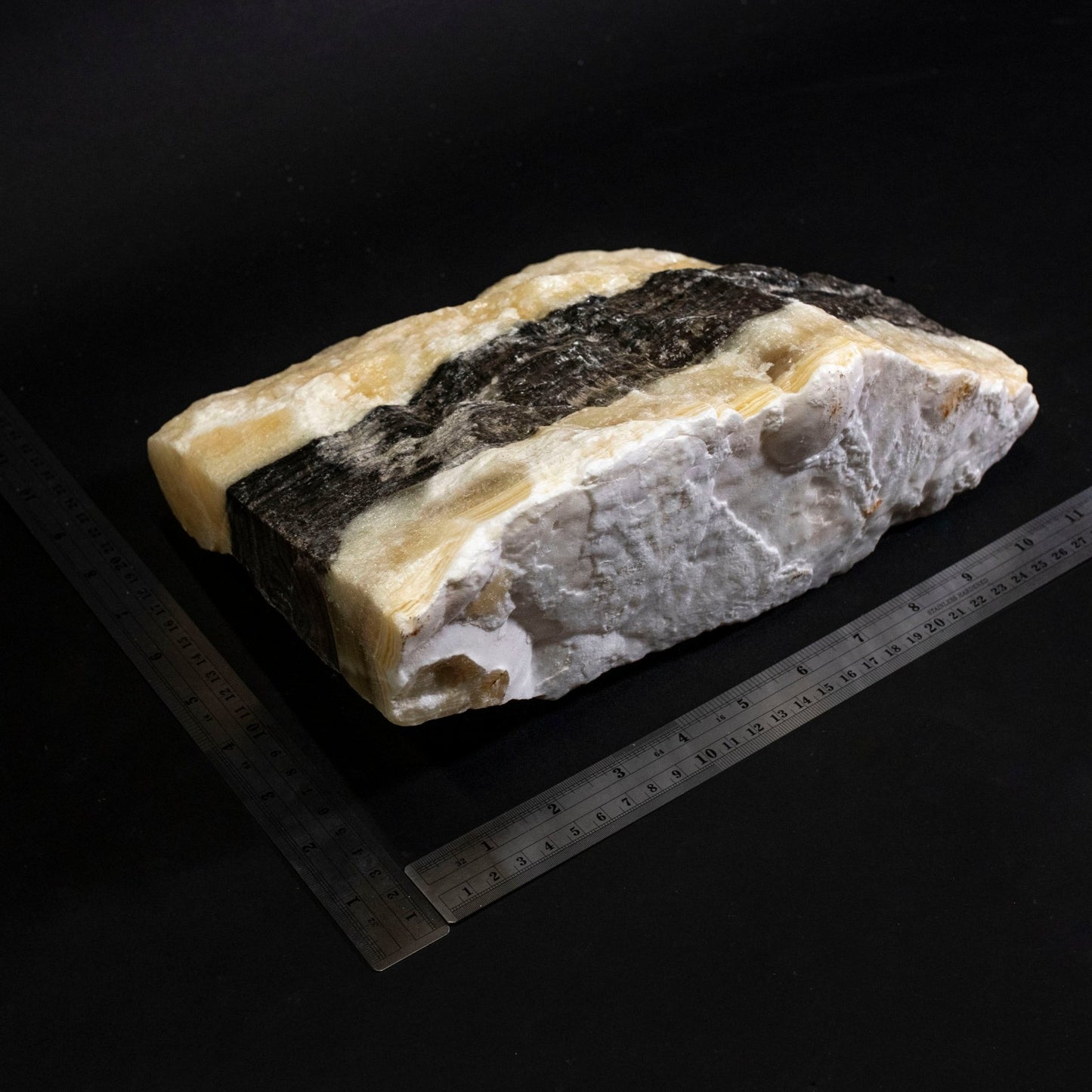 White Stone With Black Stripes and Two Metal Rulers - Zebra Calcite