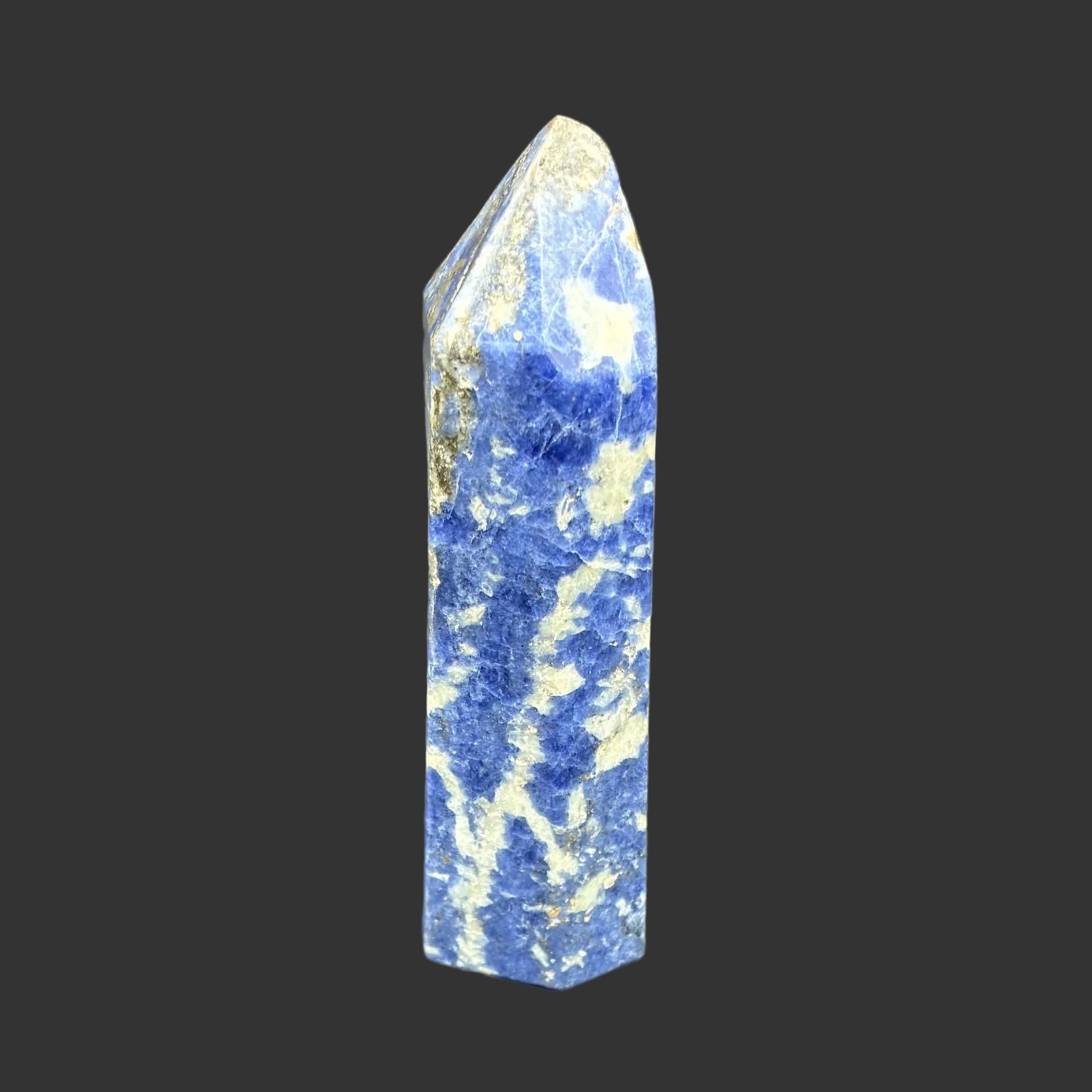 This is the left side of this polished blue Sodalite tower.