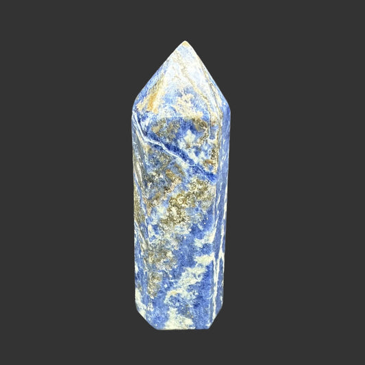This is the front side of this polished Sodalite tower. It is blue, white, and brown in color.