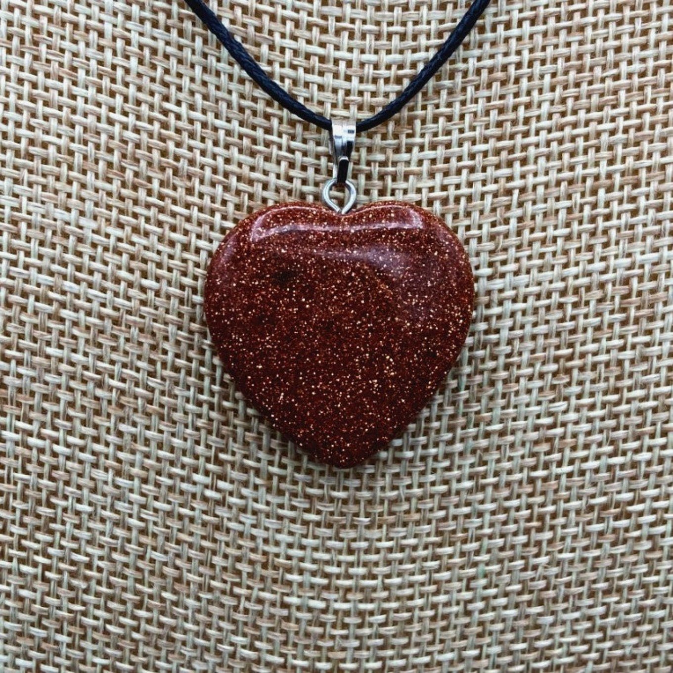 Close Up Of Heart Shaped Goldstone Pendent