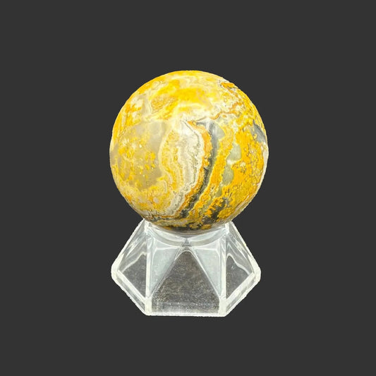 This is the front side of this polished Bumblebee Jasper sphere, in front of a black background.