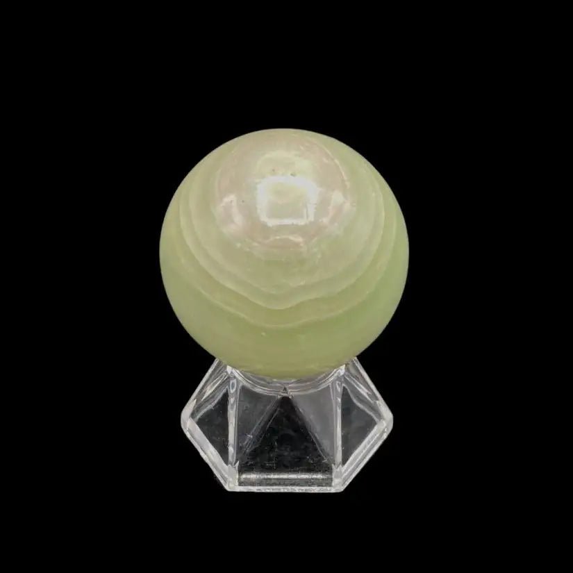 Bottom Of Green Calcite Sphere sitting on a clear display stand