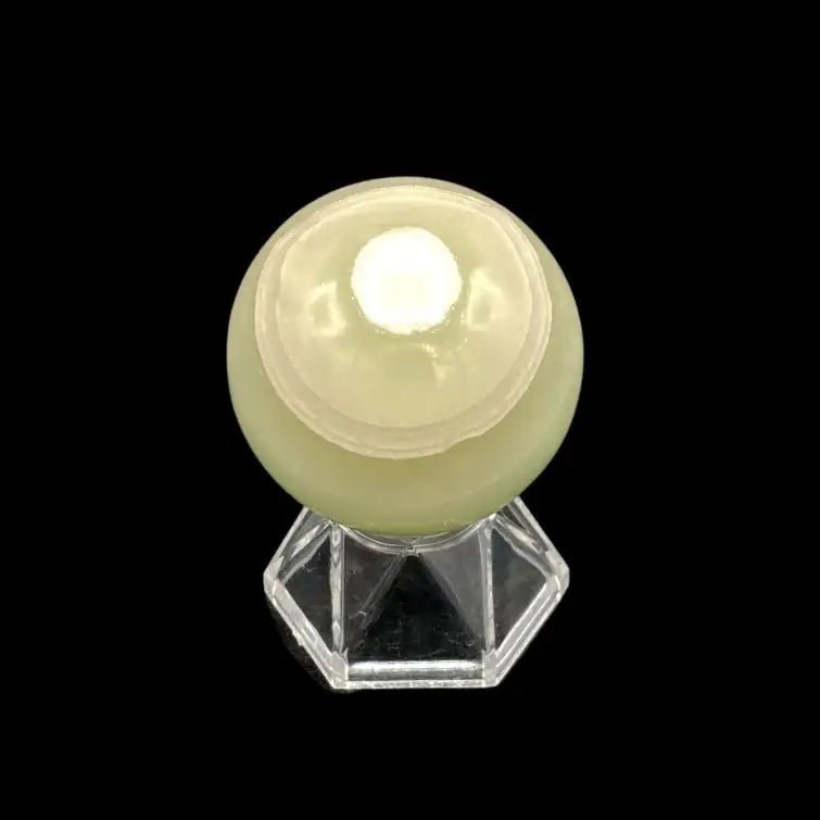 Top Of Green Calcite Sphere sitting on a clear display stand