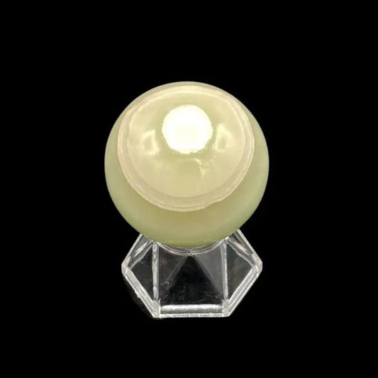 Top Of Green Calcite Sphere sitting on a clear display stand